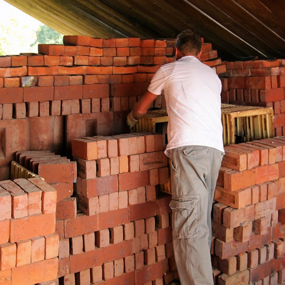 brick craftsmen making handmade baked bricks by hand
