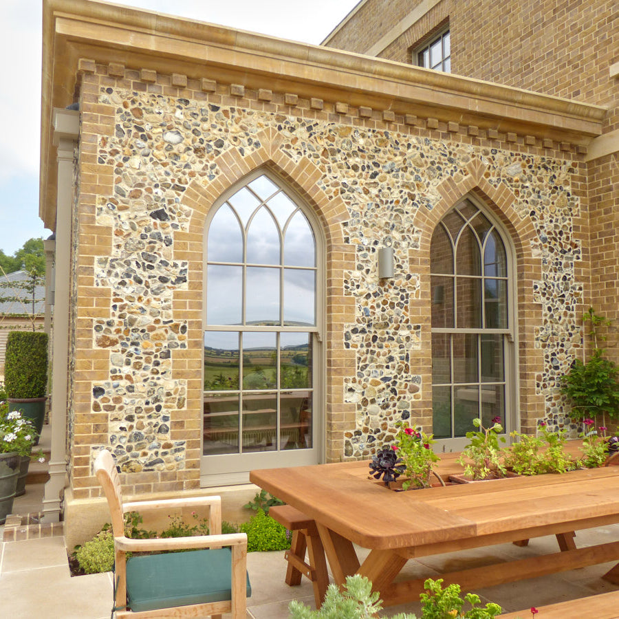 private house extension with buff yellow bricks and knapped flint walling stone