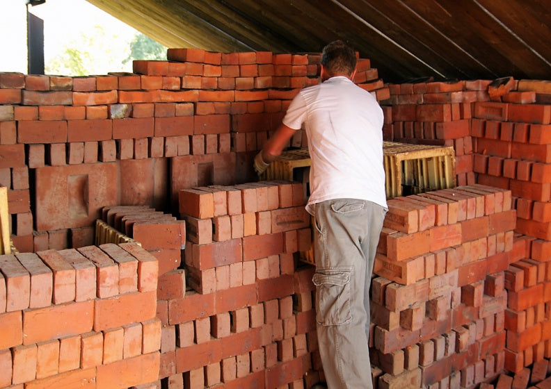 brick craftsmen making handmade baked bricks by hand